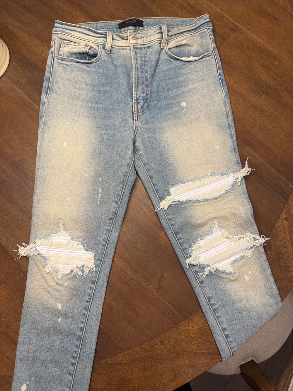 AMIRI distressed Light Wash Skinny Jeans with Distressed Knees